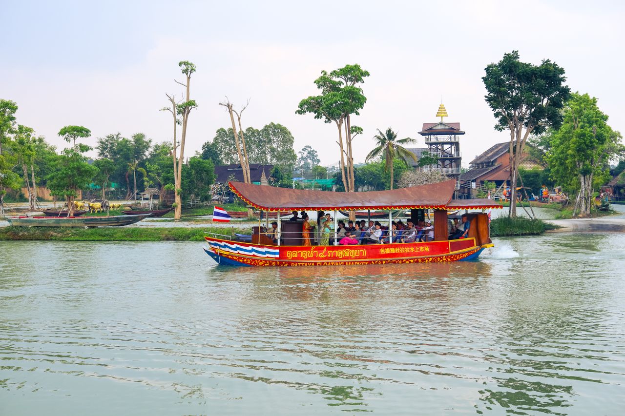 Scenic river view with traditional Thai boat